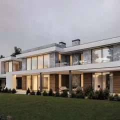 Nowoczesny, dwukondygnacyjny dom z dużymi oknami i ceglaną elewacją, otoczony zielonym ogrodem.